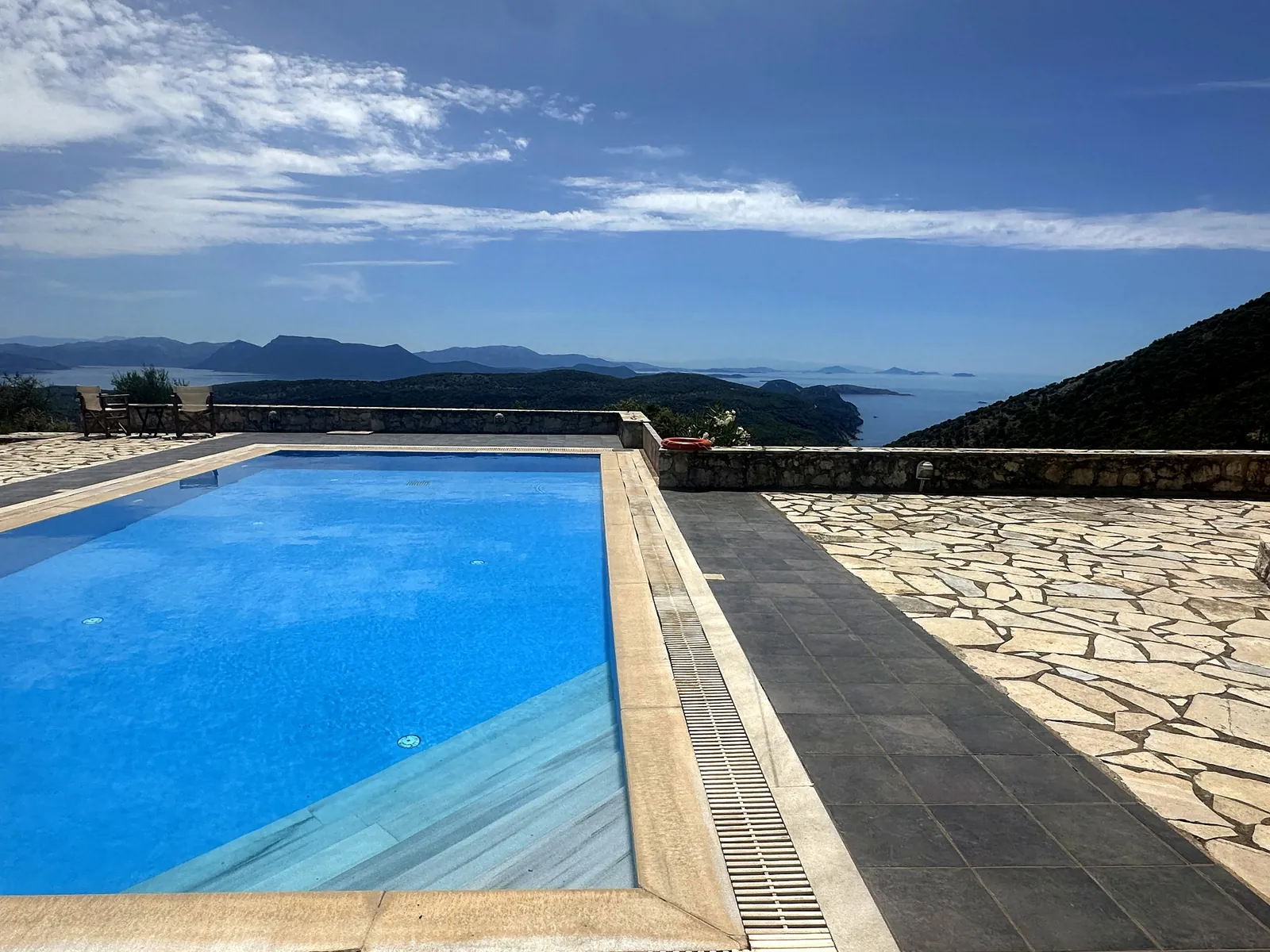 The pool edge and stone terrace looking east over the water