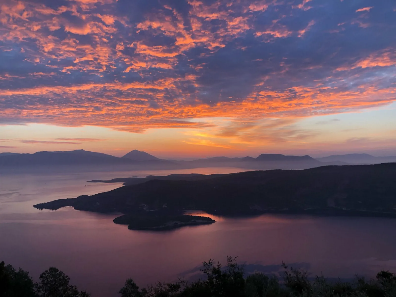 Sunrise over the strait and the mainland mountains
