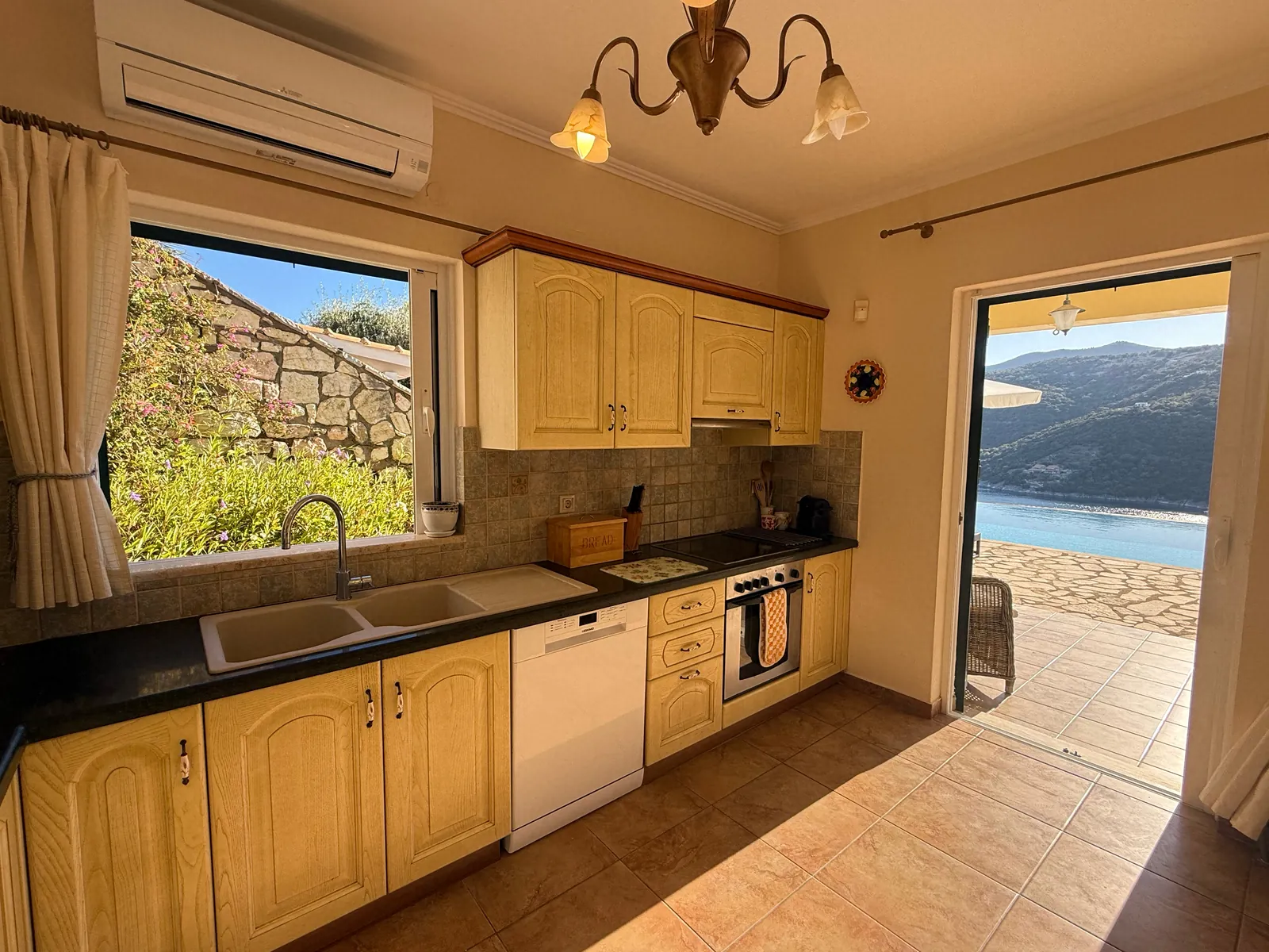 The kitchen, with its door to the terrace and the sea