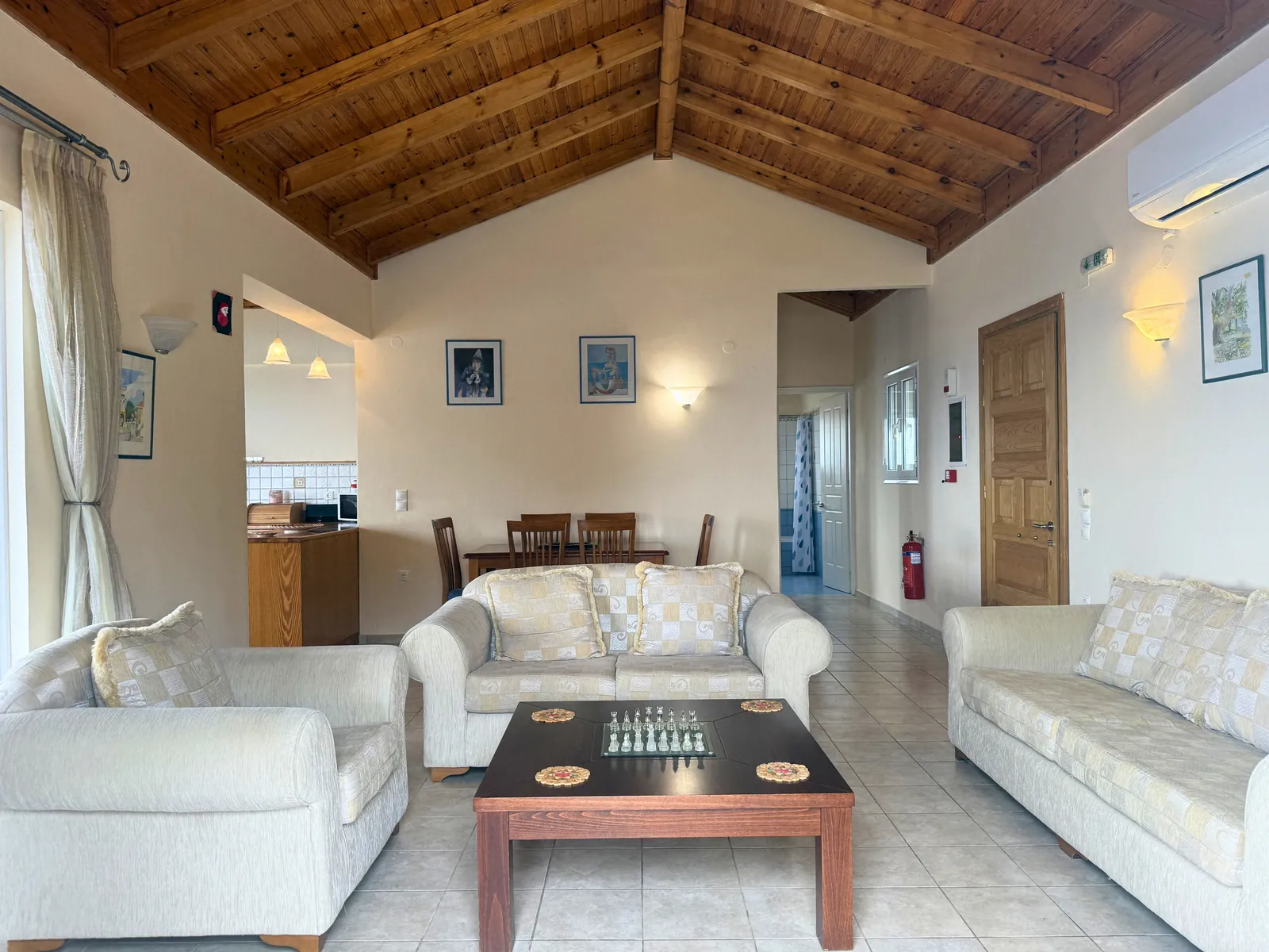 Open living and dining room under a timber roof