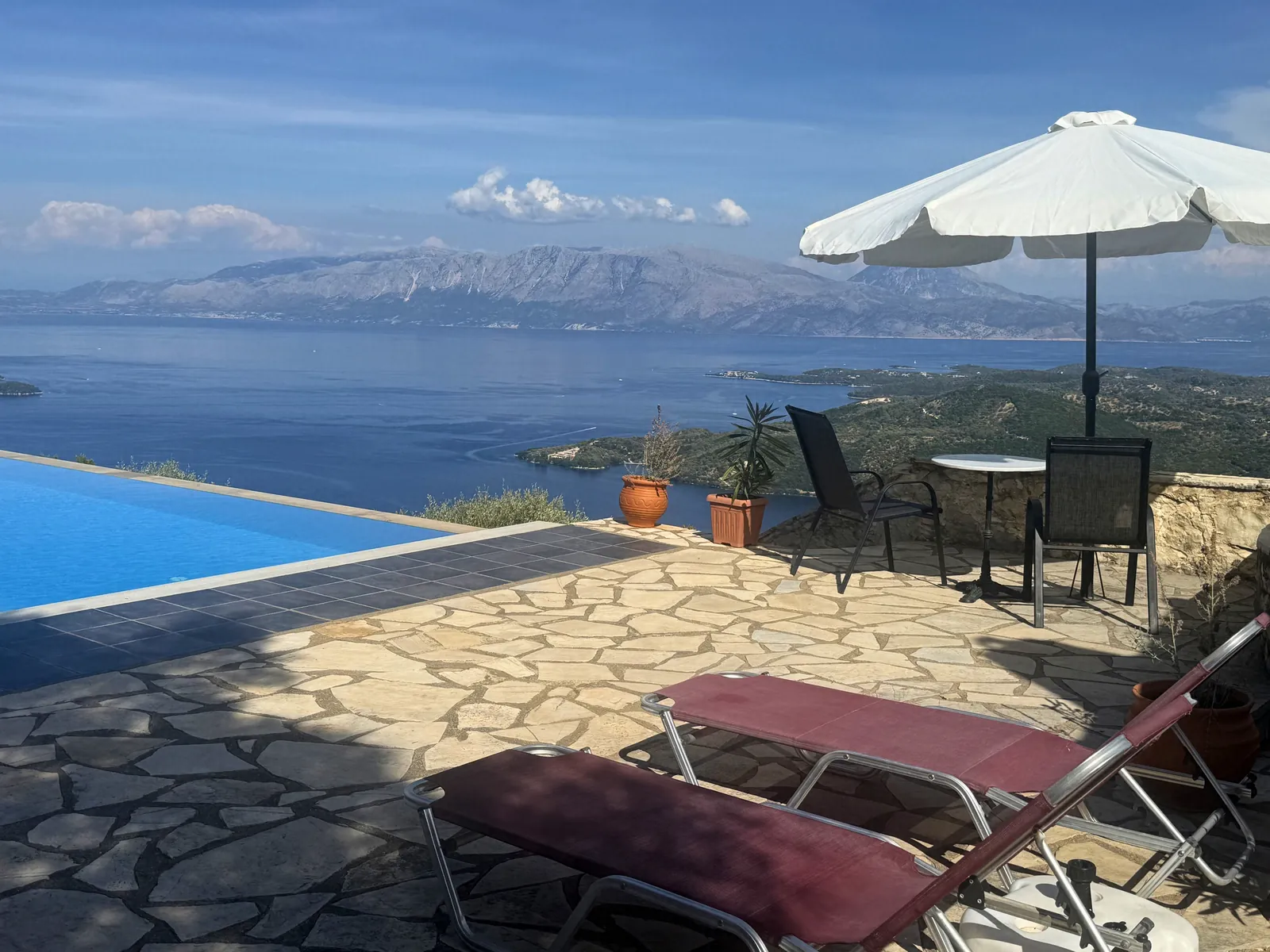 Sun loungers and umbrella beside the pool