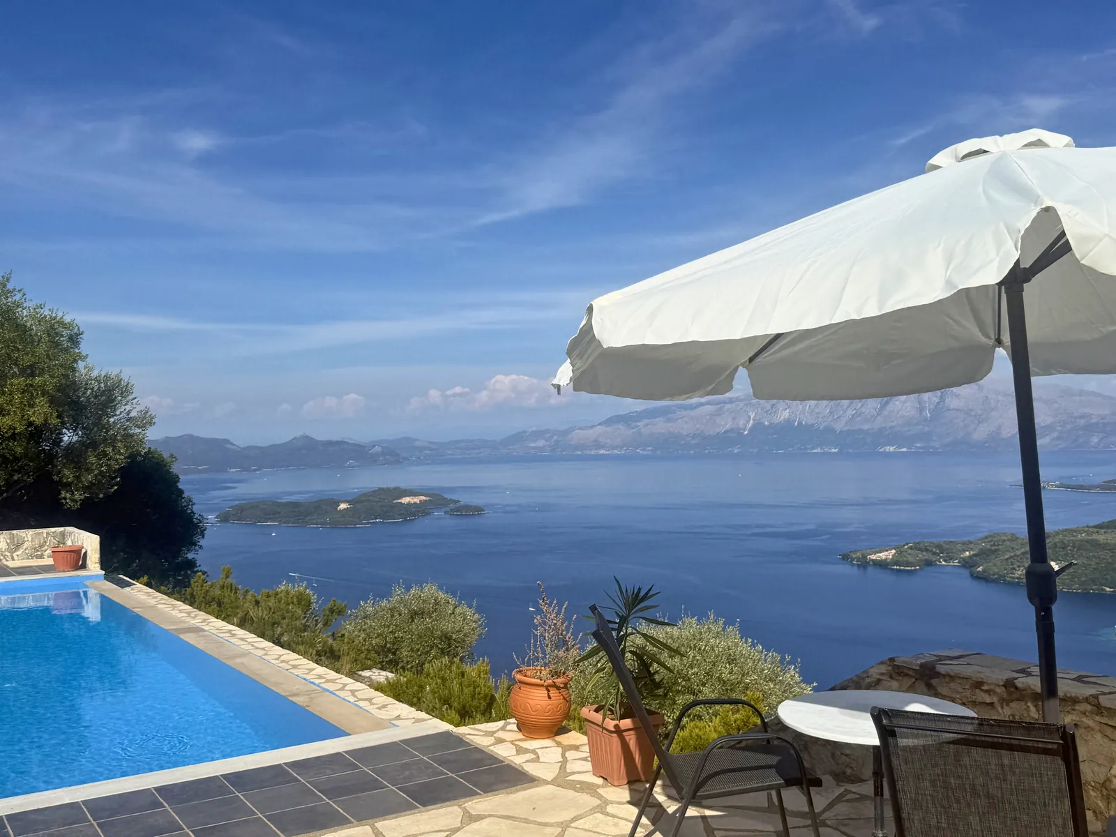 Table by the pool under the umbrella
